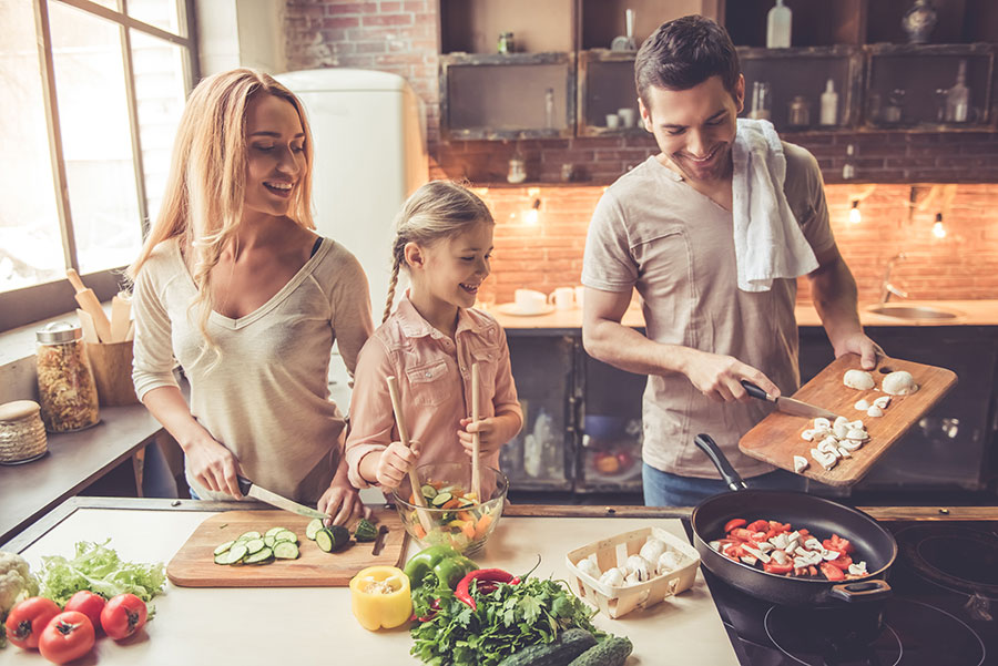 family in the kitchen preparing and cooking together